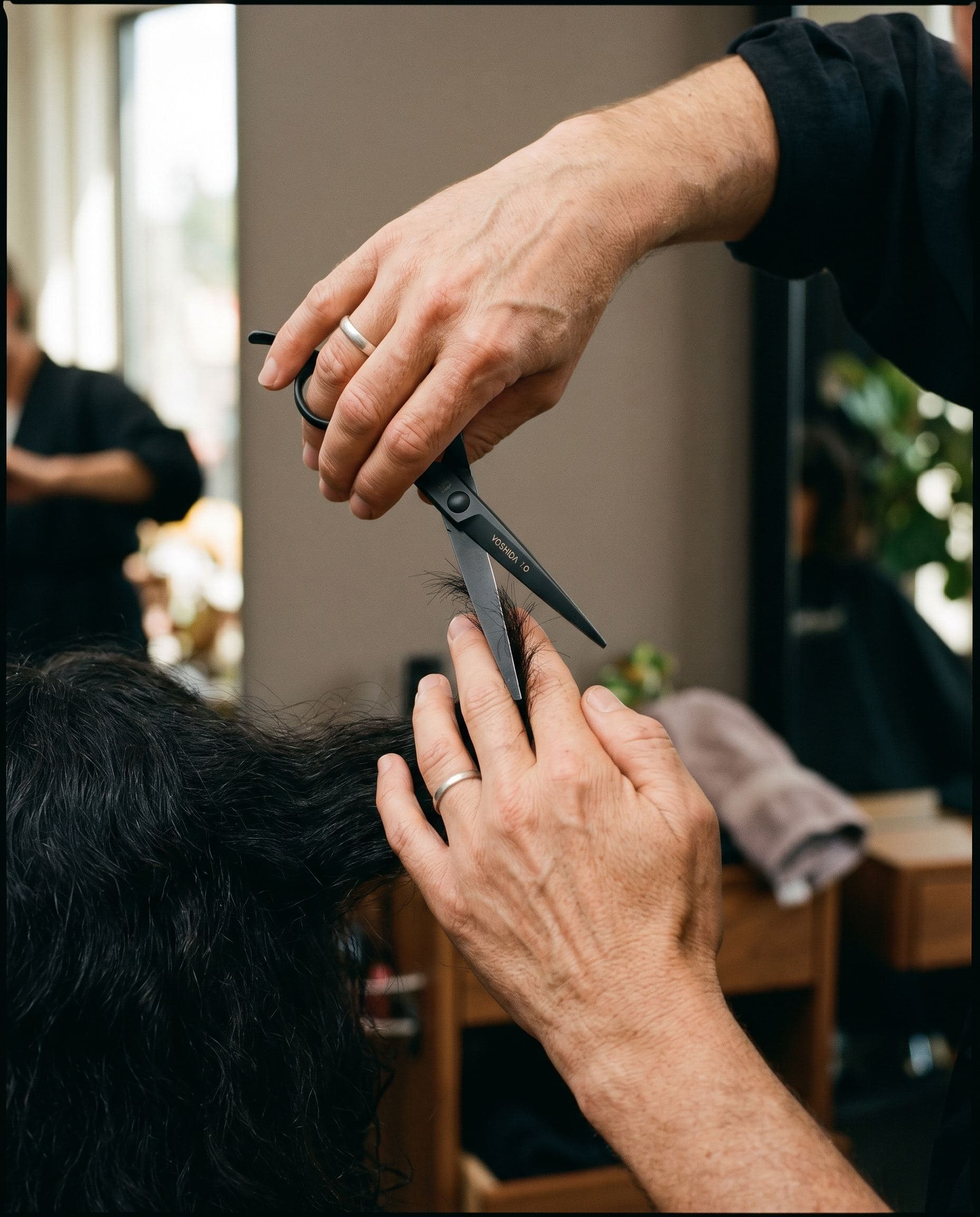 A hairdresser's hands holding professional shears